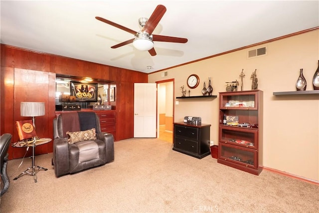 3152 Parkside Dr, San Bernardino, CA 92404 - living area with carpet flooring, ceiling fan, wood walls, crown molding, and baseboards