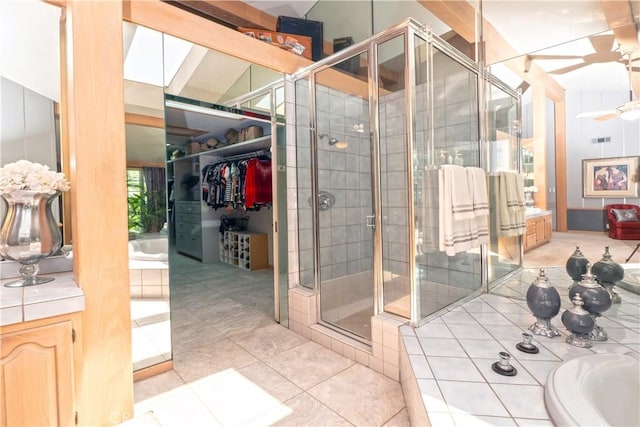 3152 Parkside Dr, San Bernardino, CA 92404 - bathroom featuring a stall shower, tile patterned floors, a bath, and a walk in closet