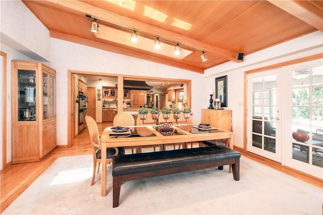 3152 Parkside Dr, San Bernardino, CA 92404 - dining space featuring rail lighting, light wood-style flooring, baseboards, french doors, and wood ceiling with exposed beams