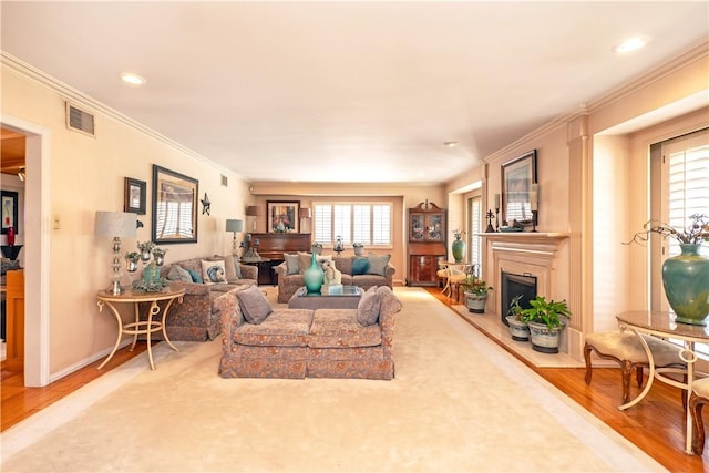 3152 Parkside Dr, San Bernardino, CA 92404 - living area featuring wood finished floors, a fireplace with raised hearth, crown molding, recessed lighting, and baseboards