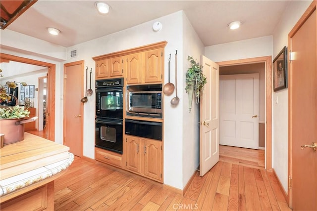 3152 Parkside Dr, San Bernardino, CA 92404 - kitchen with a warming drawer, stainless steel microwave, light wood-style floors, and light brown cabinets