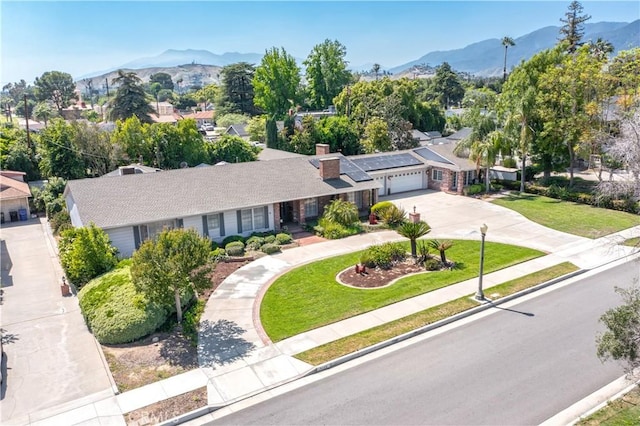 3152 Parkside Dr, San Bernardino, CA 92404 - view of front of home featuring concrete driveway, an attached garage, and a mountain view