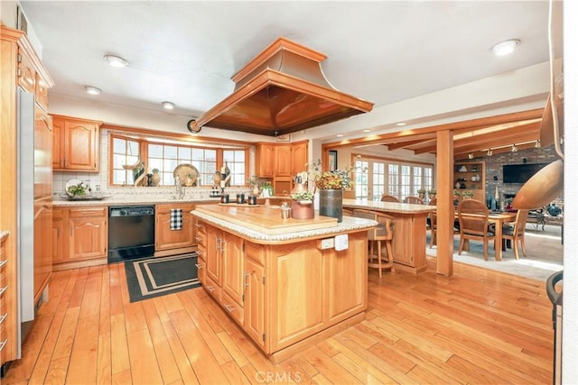 3152 Parkside Dr, San Bernardino, CA 92404 - kitchen with black dishwasher, a kitchen island, plenty of natural light, light wood finished floors, and recessed lighting