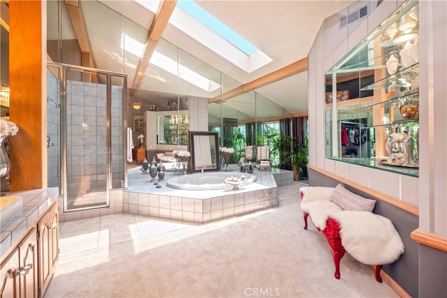 3152 Parkside Dr, San Bernardino, CA 92404 - bathroom with a skylight, vaulted ceiling, a stall shower, a garden tub, and vanity