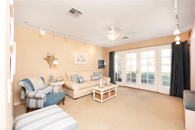 3152 Parkside Dr, San Bernardino, CA 92404 - carpeted living area featuring track lighting, french doors, and a ceiling fan