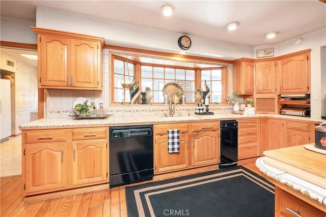 3152 Parkside Dr, San Bernardino, CA 92404 - kitchen featuring black dishwasher, a sink, freestanding refrigerator, light countertops, and decorative backsplash