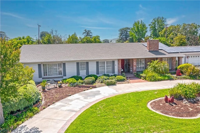 3152 Parkside Dr, San Bernardino, CA 92404 - single story home with a front lawn, a chimney, an attached garage, and brick siding