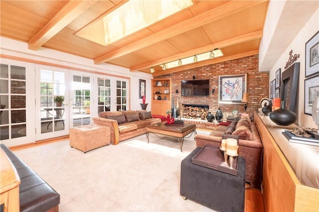 3152 Parkside Dr, San Bernardino, CA 92404 - living area featuring french doors, a brick fireplace, track lighting, and wood ceiling with exposed beams