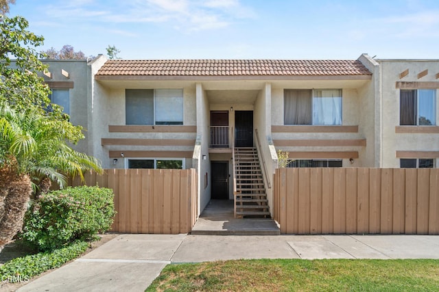 205 W Channel Islands Blvd, Port Hueneme, CA 93041 - townhome / multi-family property with stairway, a tiled roof, and stucco siding