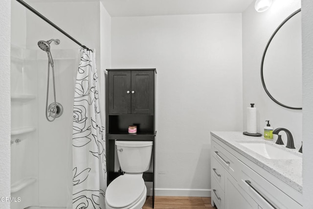 205 W Channel Islands Blvd, Port Hueneme, CA 93041 - bathroom with vanity, toilet, wood finished floors, a shower with shower curtain, and baseboards