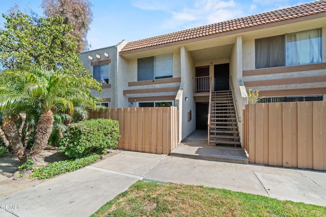 205 W Channel Islands Blvd, Port Hueneme, CA 93041 - townhome / multi-family property featuring a tiled roof, stairway, and stucco siding