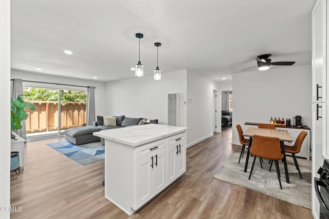 205 W Channel Islands Blvd, Port Hueneme, CA 93041 - kitchen featuring light wood finished floors, white cabinets, open floor plan, decorative light fixtures, and recessed lighting