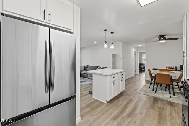 205 W Channel Islands Blvd, Port Hueneme, CA 93041 - kitchen featuring freestanding refrigerator, white cabinets, light wood-style floors, recessed lighting, and ceiling fan
