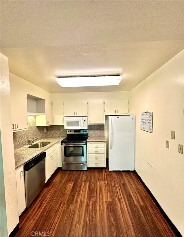 2 Panoramic Way Unit 302, Berkeley, CA 94704 - kitchen featuring appliances with stainless steel finishes, dark wood-type flooring, white cabinets, a sink, and tasteful backsplash