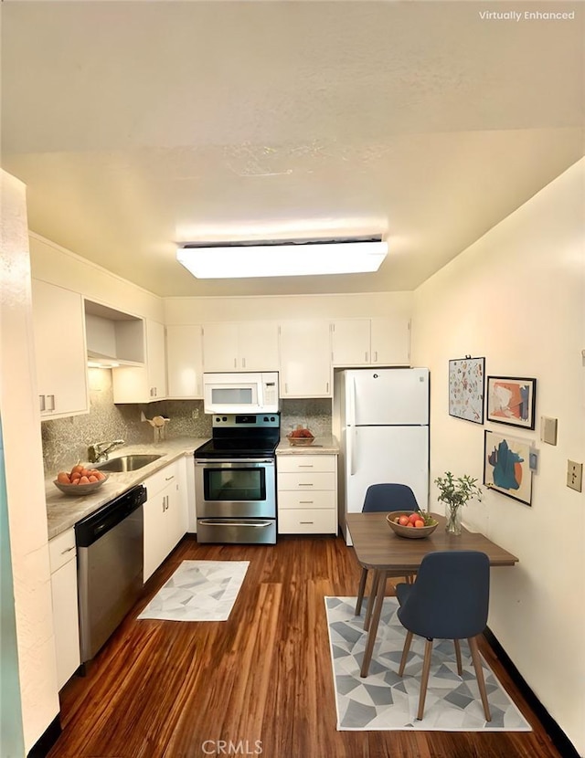 2 Panoramic Way Unit 302, Berkeley, CA 94704 - kitchen featuring stainless steel appliances, white cabinetry, decorative backsplash, dark wood-style flooring, and a sink