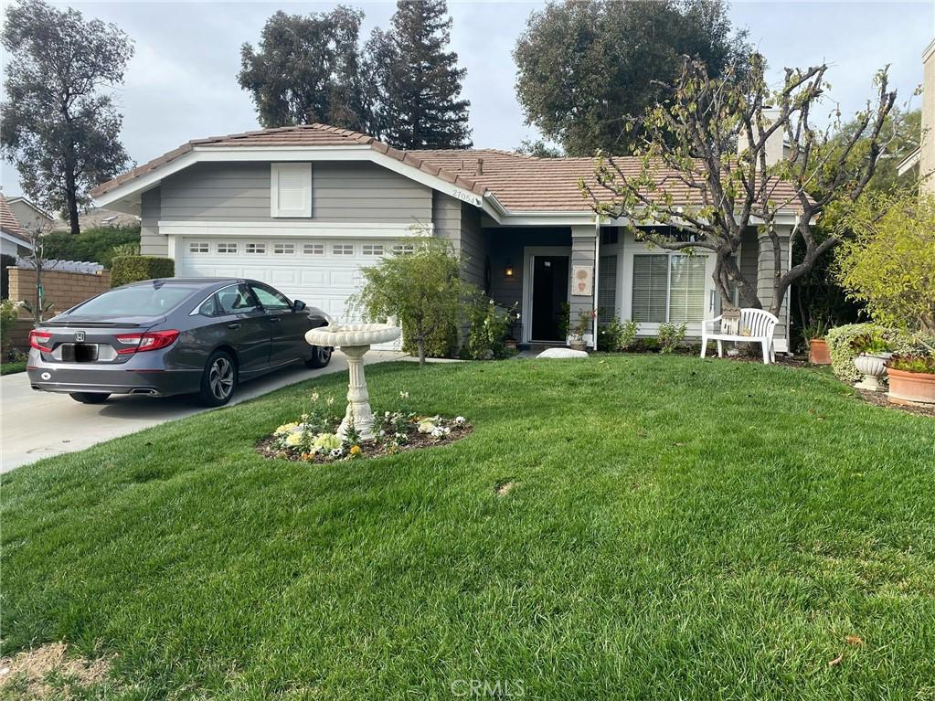 27054 Riversbridge Way, Valencia, CA 91354 - ranch-style home with a garage, a front yard, a tile roof, and concrete driveway