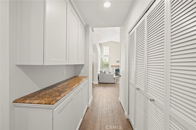 27054 Riversbridge Way, Valencia, CA 91354 - hallway with hardwood / wood-style flooring, arched walkways, and recessed lighting