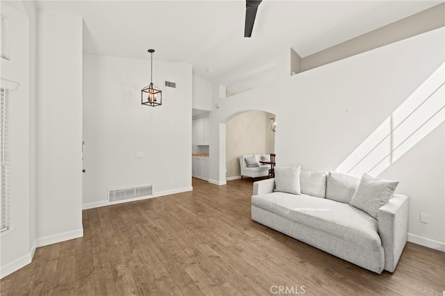 27054 Riversbridge Way, Valencia, CA 91354 - living area featuring arched walkways, wood finished floors, and high vaulted ceiling