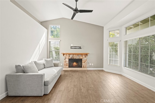 27054 Riversbridge Way, Valencia, CA 91354 - living area with a ceiling fan, hardwood / wood-style flooring, a stone fireplace, and high vaulted ceiling