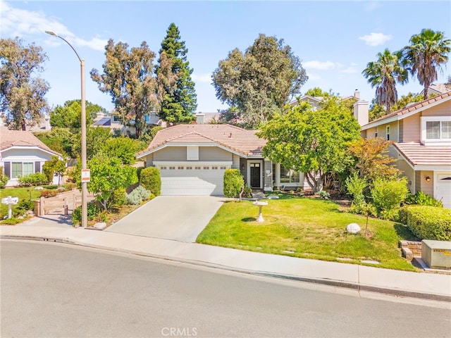 27054 Riversbridge Way, Valencia, CA 91354 - view of front of house featuring a front yard, driveway, a tiled roof, and a residential view