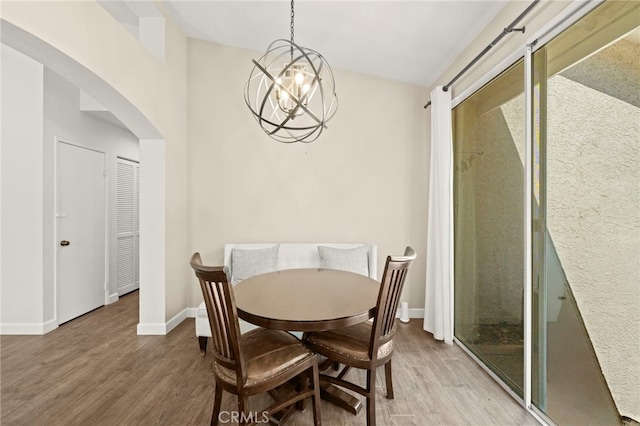 27054 Riversbridge Way, Valencia, CA 91354 - dining area with arched walkways, wood finished floors, and a chandelier