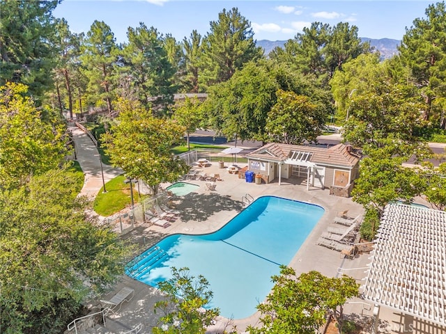27054 Riversbridge Way, Valencia, CA 91354 - community pool featuring a patio area, a mountain view, and view of wooded area