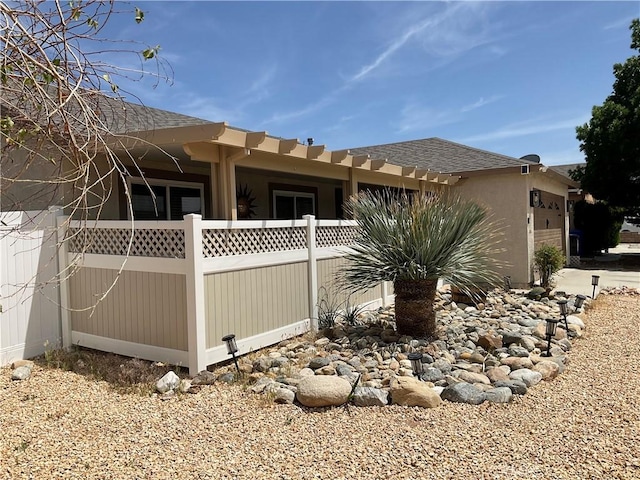 17911 Juniper St, Adelanto, CA 92301 - view of side of property featuring an attached garage and stucco siding