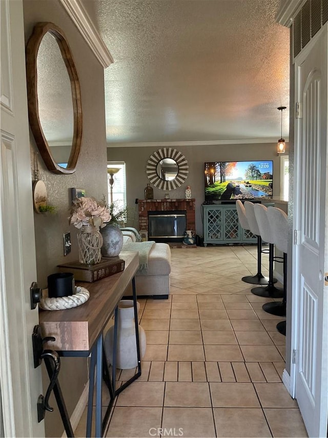 17911 Juniper St, Adelanto, CA 92301 - entryway featuring a textured ceiling, crown molding, light tile patterned floors, and a fireplace