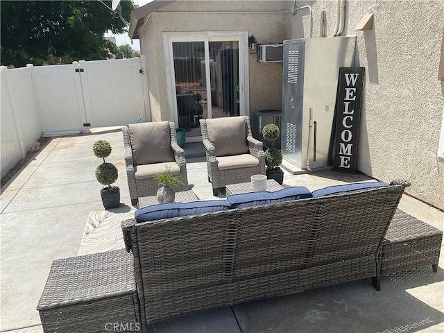 17911 Juniper St, Adelanto, CA 92301 - view of patio with an outdoor living space, central AC, and a wall mounted air conditioner