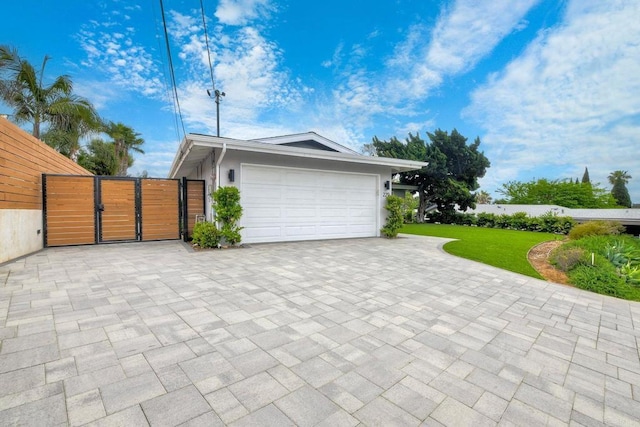229 Yacon St, Vista, CA 92083 - garage featuring a gate and decorative driveway
