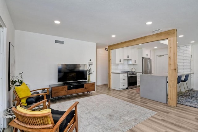 229 Yacon St, Vista, CA 92083 - living room with light wood finished floors, recessed lighting, and baseboards