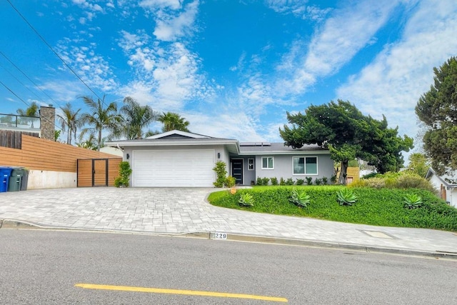 229 Yacon St, Vista, CA 92083 - single story home featuring an attached garage, roof mounted solar panels, stucco siding, and decorative driveway