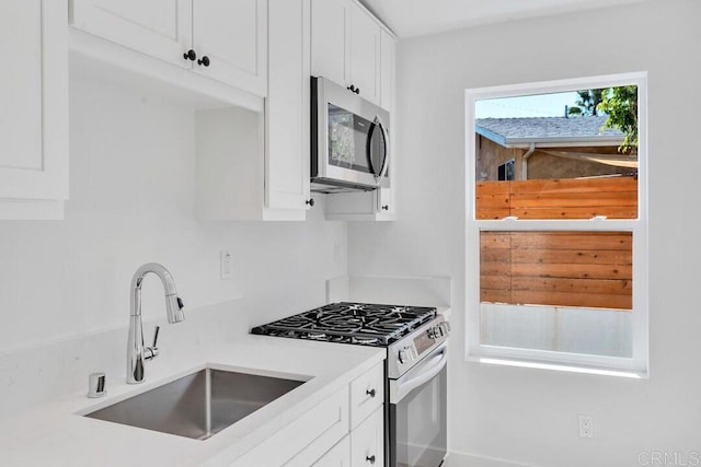 229 Yacon St, Vista, CA 92083 - kitchen featuring stainless steel appliances, a sink, white cabinets, and light countertops