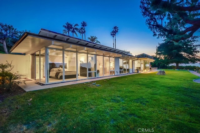 27649 Palos Verdes Dr E, Rancho Palos Verdes, CA 90275 - back of house at dusk featuring a yard, a patio area, and a sunroom