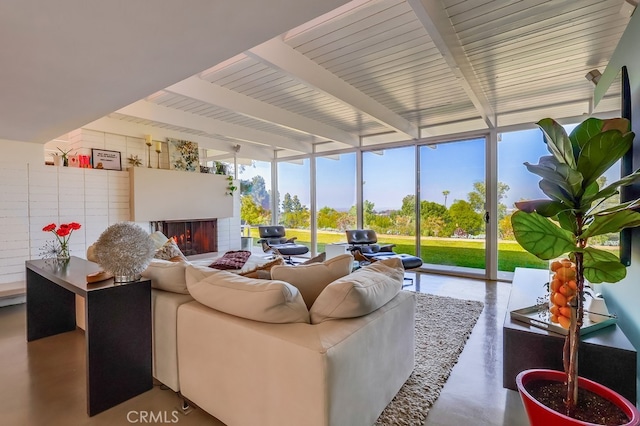 27649 Palos Verdes Dr E, Rancho Palos Verdes, CA 90275 - living area with finished concrete flooring, beamed ceiling, a fireplace, and floor to ceiling windows