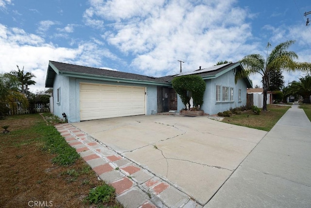 3603 W 144th Pl, Hawthorne, CA 90250 - ranch-style home featuring stucco siding, concrete driveway, roof mounted solar panels, and a garage