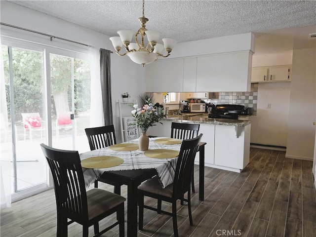 15043 S Culver Rd, Victorville, CA 92394 - dining area with a chandelier, dark wood-style floors, and a textured ceiling