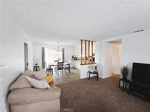 15043 S Culver Rd, Victorville, CA 92394 - living area featuring a chandelier, a textured ceiling, and carpet