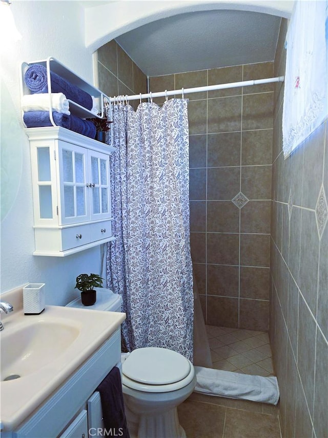 15043 S Culver Rd, Victorville, CA 92394 - full bathroom with vanity, toilet, a tile shower, and tile patterned floors