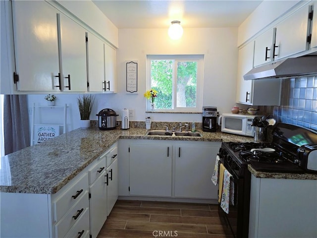 15043 S Culver Rd, Victorville, CA 92394 - kitchen featuring gas stove, a sink, under cabinet range hood, white microwave, and dark wood-type flooring