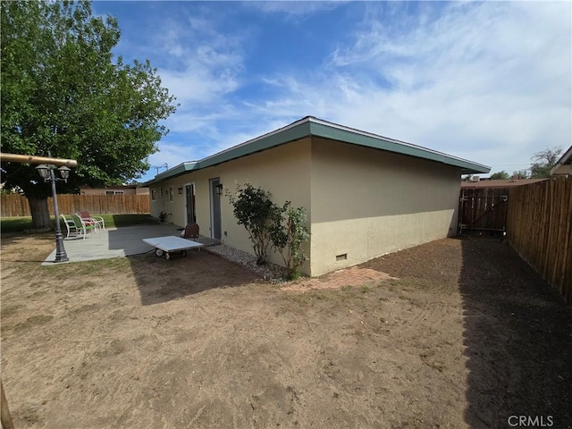 15043 S Culver Rd, Victorville, CA 92394 - view of side of property with a fenced backyard, a patio area, and stucco siding