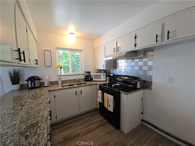 15043 S Culver Rd, Victorville, CA 92394 - kitchen featuring black range with gas stovetop, a sink, white microwave, under cabinet range hood, and white cabinets