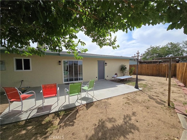15043 S Culver Rd, Victorville, CA 92394 - back of house with stucco siding, a fenced backyard, and a patio