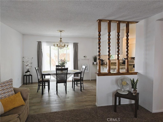 15043 S Culver Rd, Victorville, CA 92394 - dining area with a chandelier, wood finished floors, a textured ceiling, and baseboards