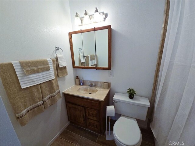 15043 S Culver Rd, Victorville, CA 92394 - bathroom featuring vanity, toilet, curtained shower, and tile patterned flooring