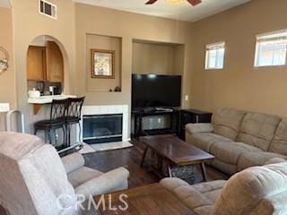 39244 Turtle Bay Ln Unit F, Murrieta, CA 92563 - living area with a ceiling fan, wood finished floors, and a glass covered fireplace
