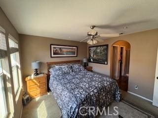 39244 Turtle Bay Ln Unit F, Murrieta, CA 92563 - bedroom with arched walkways, carpet floors, and baseboards