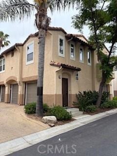 39244 Turtle Bay Ln Unit F, Murrieta, CA 92563 - view of front of property featuring an attached garage, stucco siding, a tiled roof, and driveway