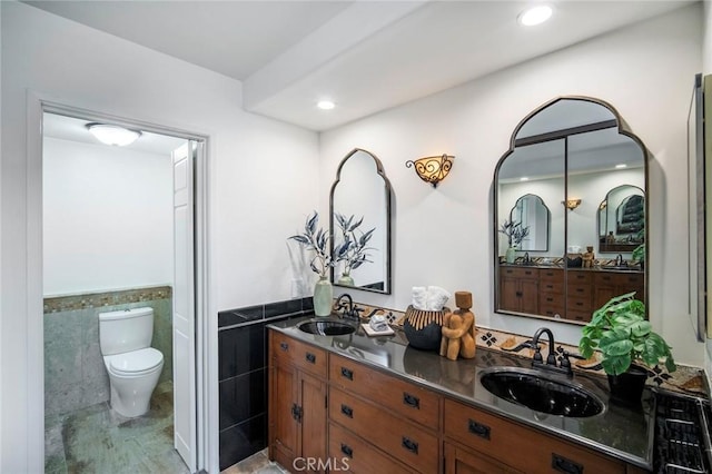 29111 Pompano Way, Laguna Niguel, CA 92677 - bathroom featuring tile walls, wainscoting, double vanity, and recessed lighting