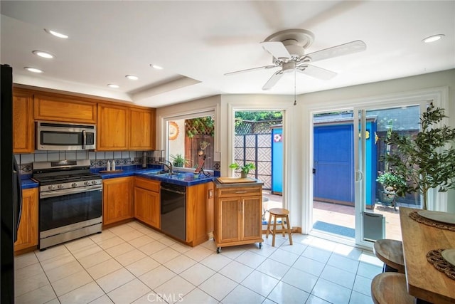 29111 Pompano Way, Laguna Niguel, CA 92677 - kitchen featuring stainless steel appliances, brown cabinetry, ceiling fan, dark countertops, and recessed lighting